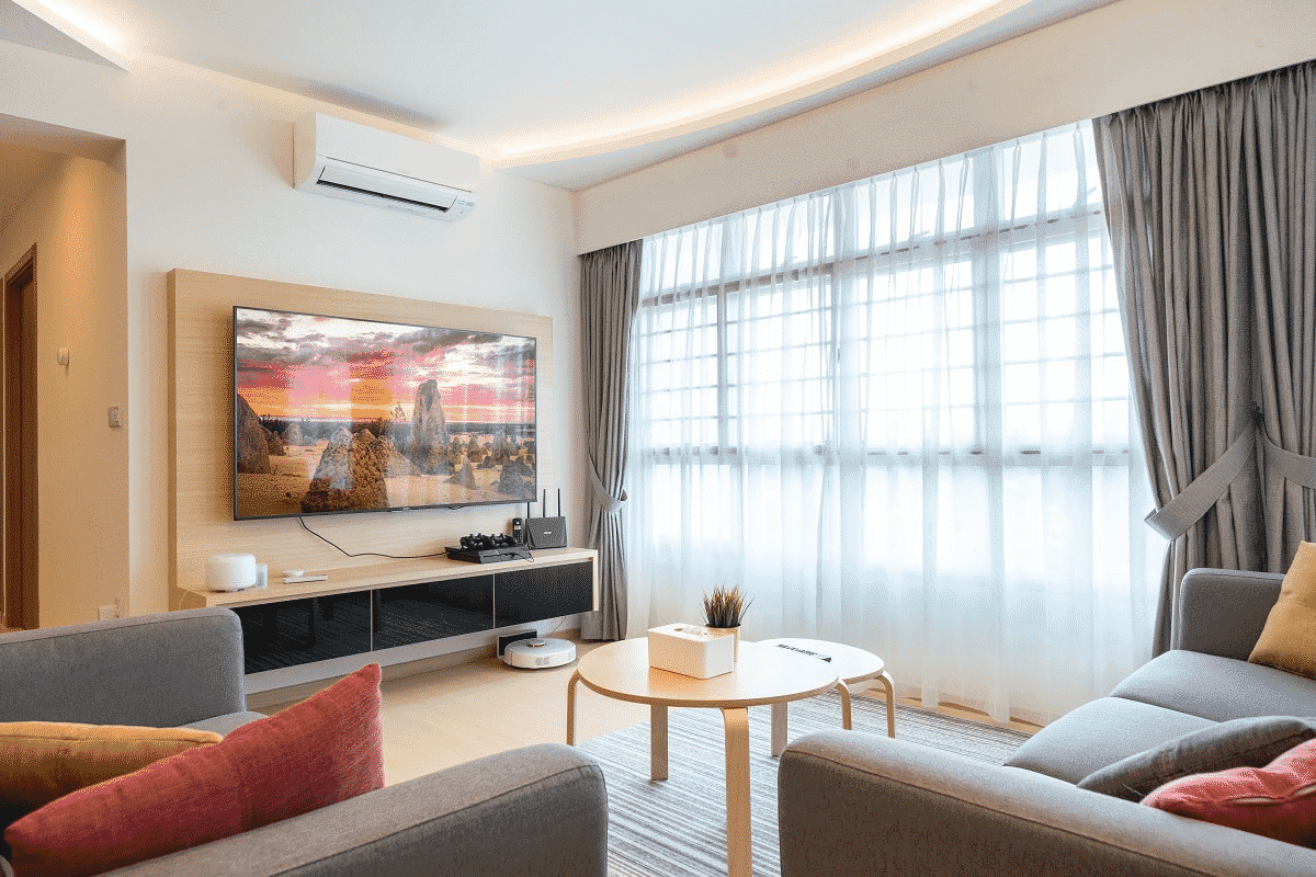 Modern small HDB living room with natural light, soft furnishings, and balanced décor arranged using Feng Shui principles recommended by a feng shui master in Singapore.
